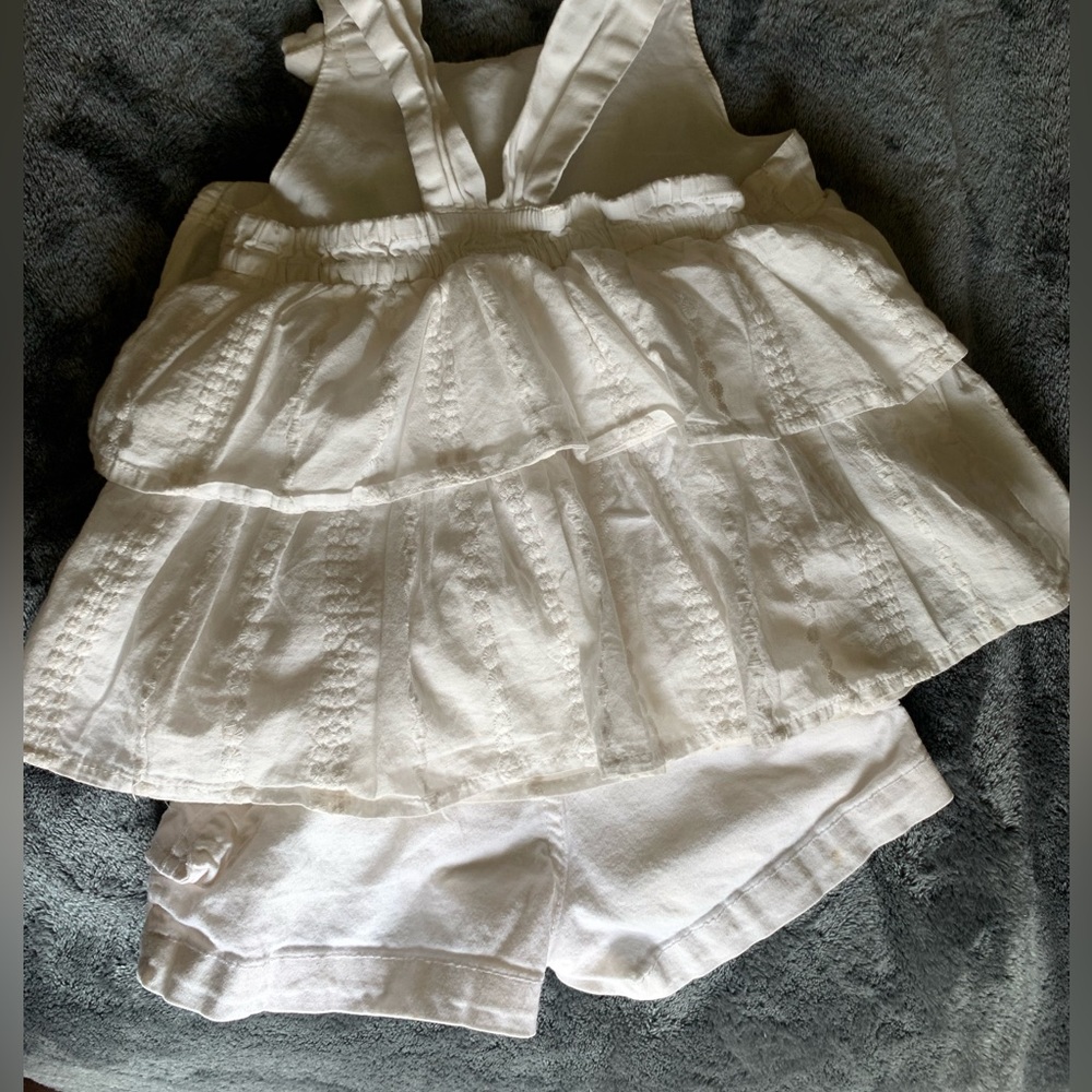 Stretchy, white shorts with side cargo pockets and belt loops with white top